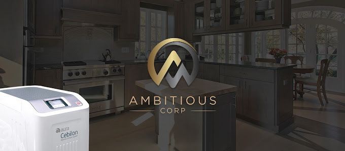 Logo of Ambitious Corp overlaid on a modern kitchen with a white appliance in the foreground.